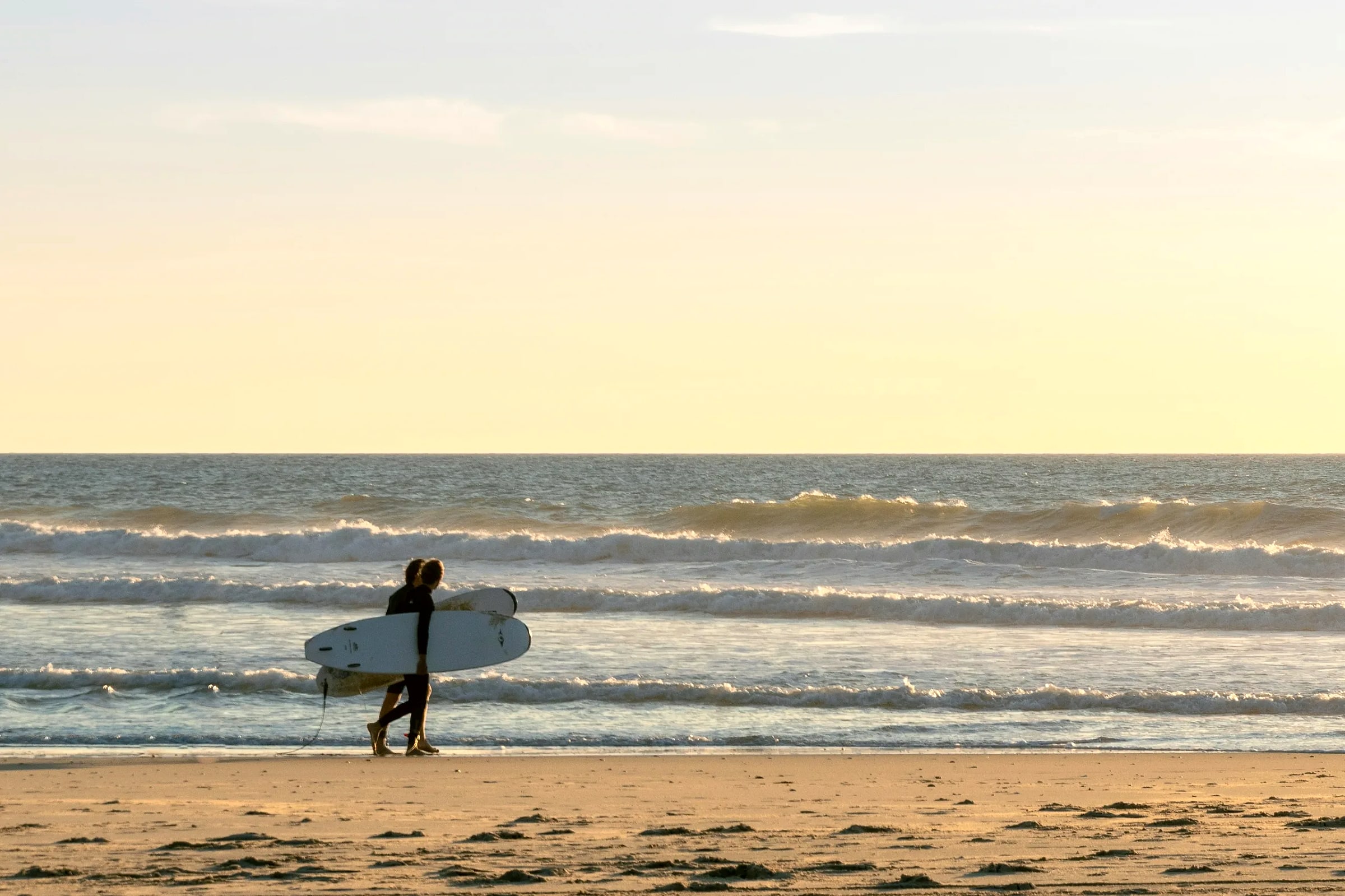 Surfers entering the water in Tamraght